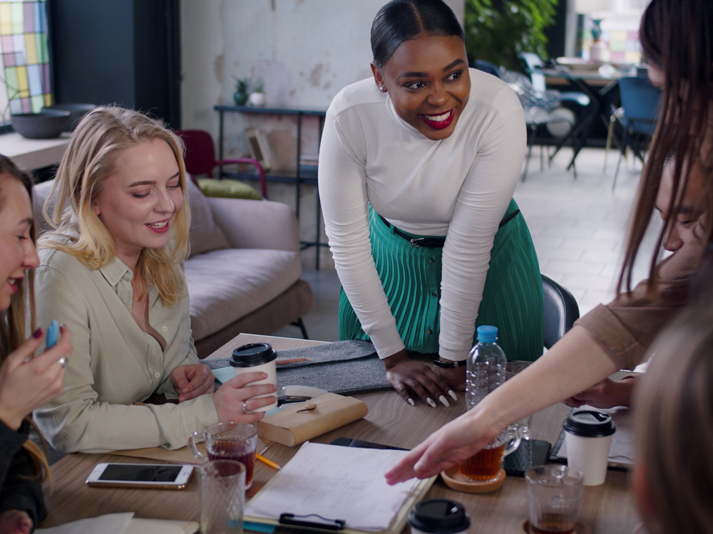 Workplace culture female founder talking to team