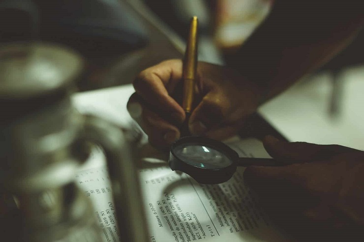 Guy with magnifying glass creating an SaaS product