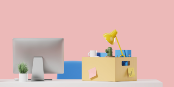 Desk with box filled someone quitting their job